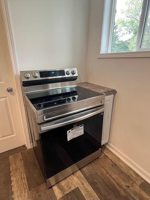 641/2 N Beaver St, Carroll, OH 43112 - kitchen with stainless steel range with electric stovetop, dark wood-style floors, and white cabinetry
