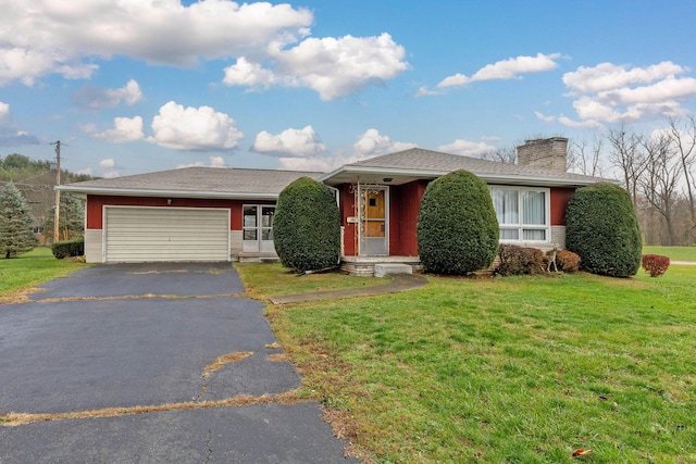 single story home featuring a garage and a front yard