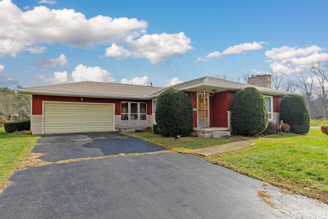 single story home featuring a front lawn and a garage