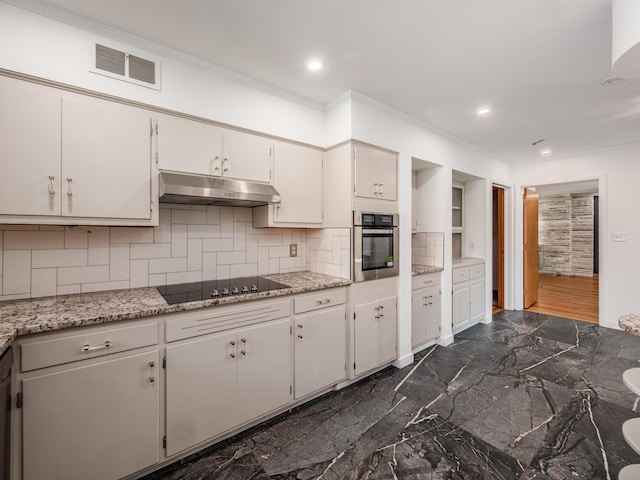 kitchen featuring white cabinetry, stainless steel oven, light stone countertops, black electric cooktop, and decorative backsplash