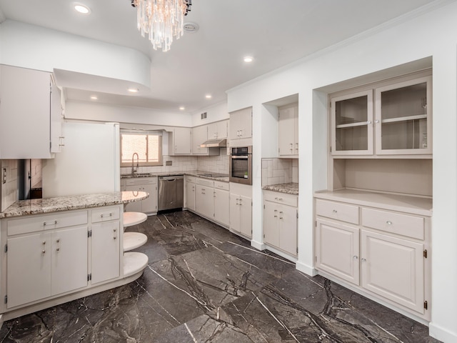 kitchen featuring tasteful backsplash, white cabinetry, sink, and stainless steel appliances