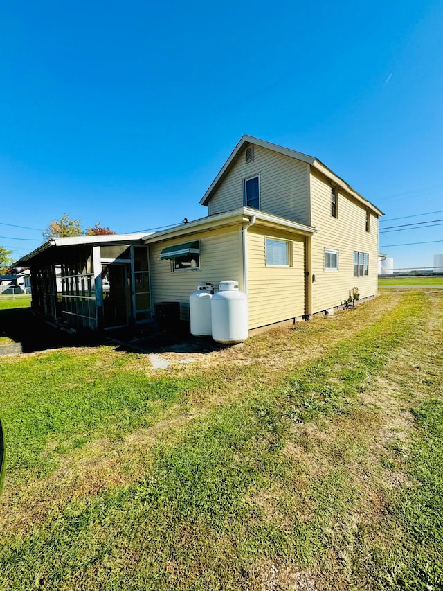 view of side of home with a yard