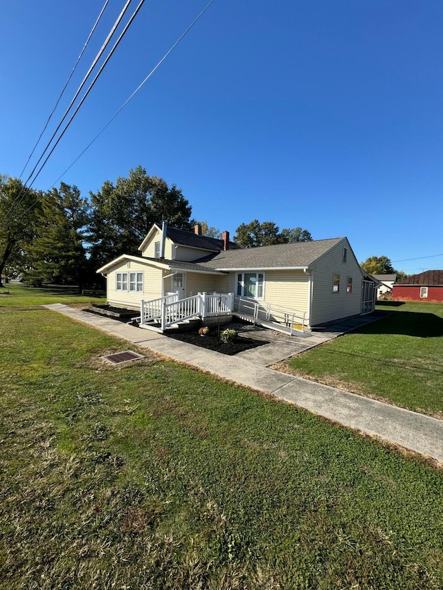 view of front facade featuring a wooden deck and a front yard