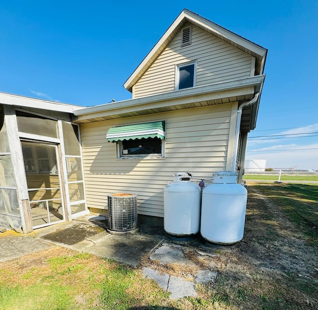 back of house featuring central air condition unit