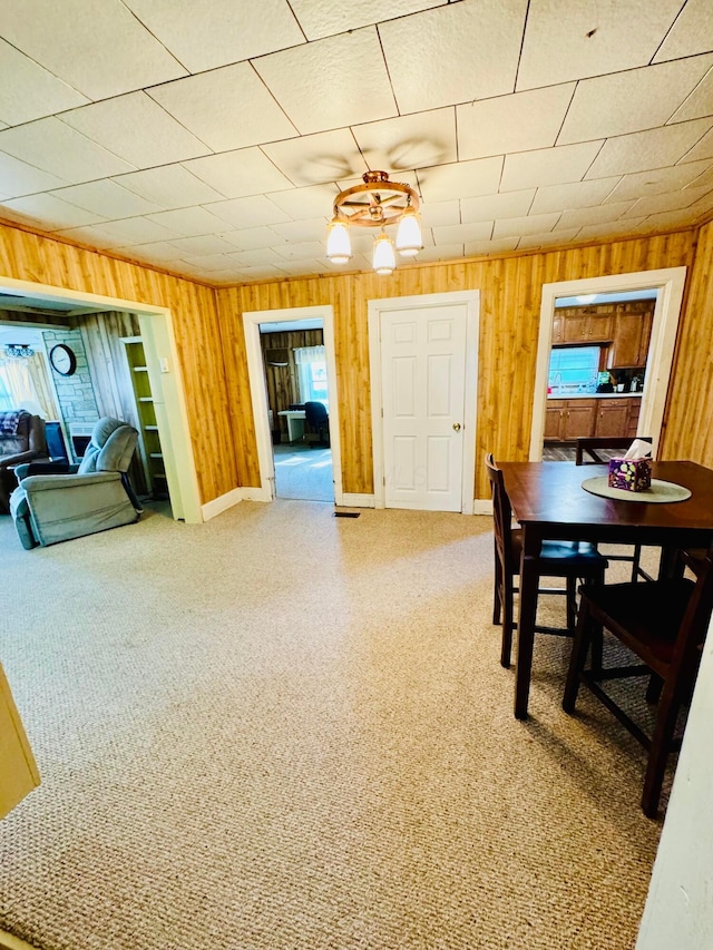 dining room with wood walls