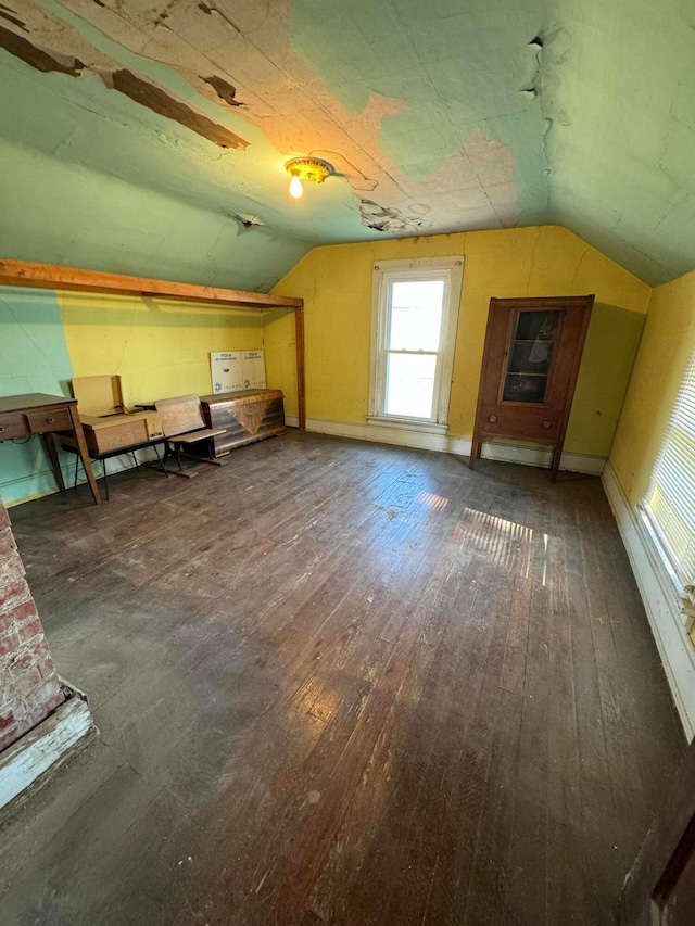 additional living space with vaulted ceiling and dark wood-type flooring