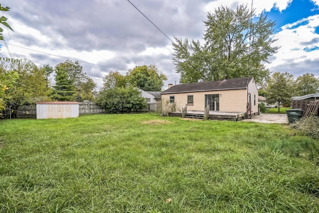 view of yard featuring a shed and a deck