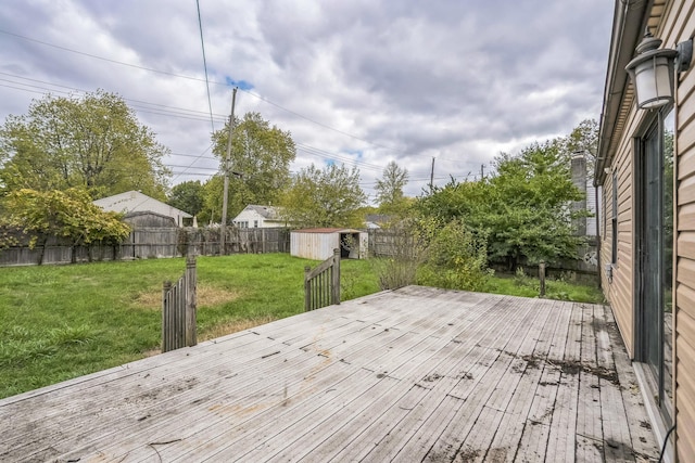 wooden deck with a shed and a yard