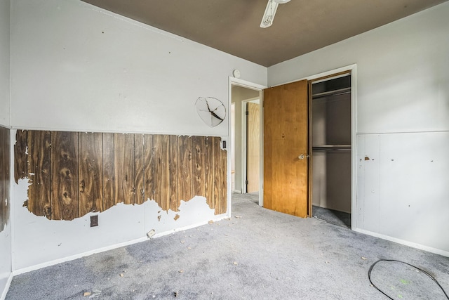 unfurnished bedroom featuring carpet and a closet