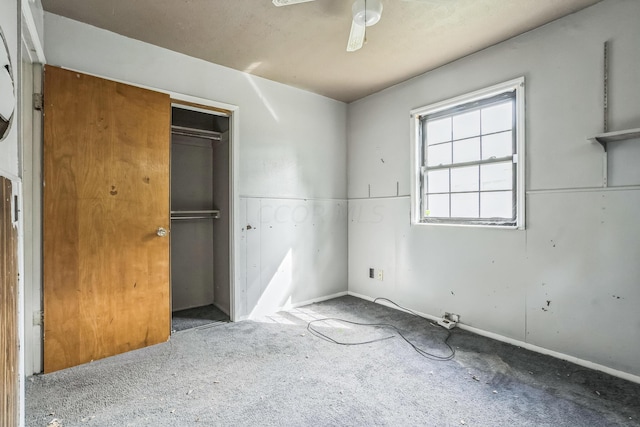 unfurnished bedroom featuring carpet, a closet, and ceiling fan