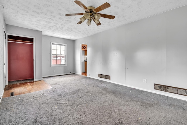 unfurnished bedroom featuring carpet, ceiling fan, and a textured ceiling