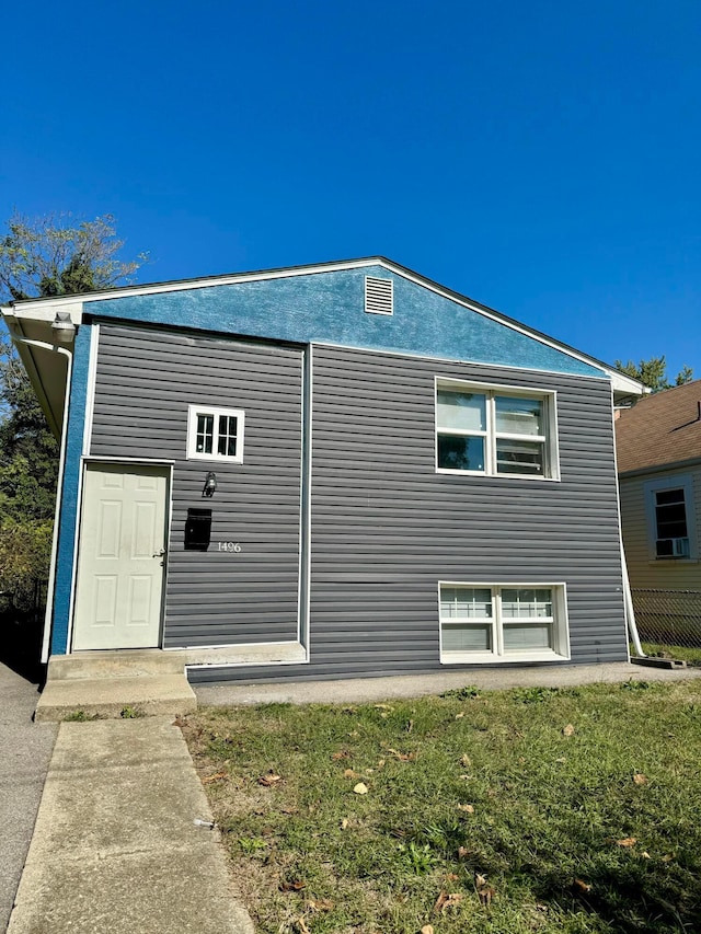 view of side of home with a yard