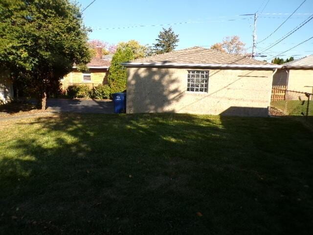 view of side of home featuring a lawn