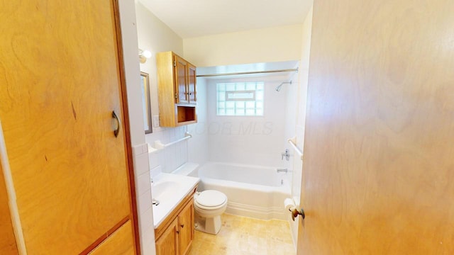 bathroom with toilet, vanity, and washtub / shower combination