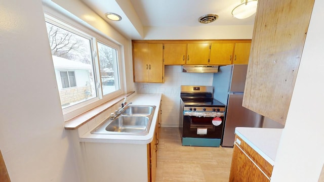 kitchen with stainless steel electric range oven, visible vents, a sink, light countertops, and under cabinet range hood