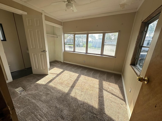 unfurnished bedroom featuring dark carpet and ceiling fan