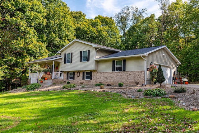 split level home featuring a garage, covered porch, and a front lawn