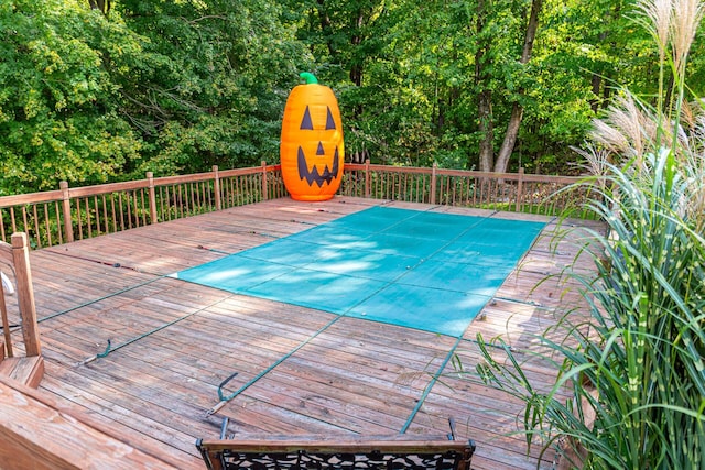 view of swimming pool featuring a deck