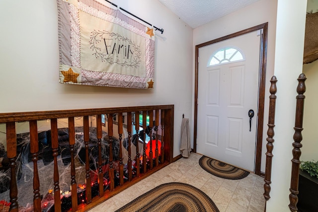 foyer entrance featuring a textured ceiling