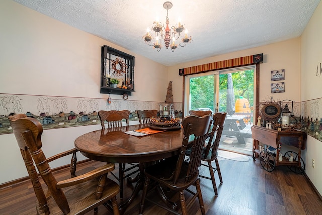 dining room with an inviting chandelier, a textured ceiling, and dark hardwood / wood-style floors