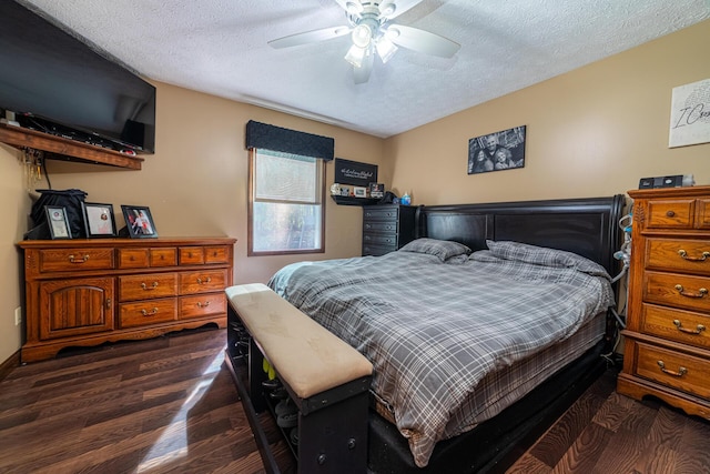 bedroom featuring ceiling fan, dark hardwood / wood-style flooring, and a textured ceiling