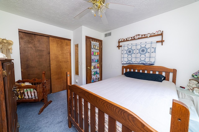 bedroom featuring a closet, carpet floors, ceiling fan, and a textured ceiling