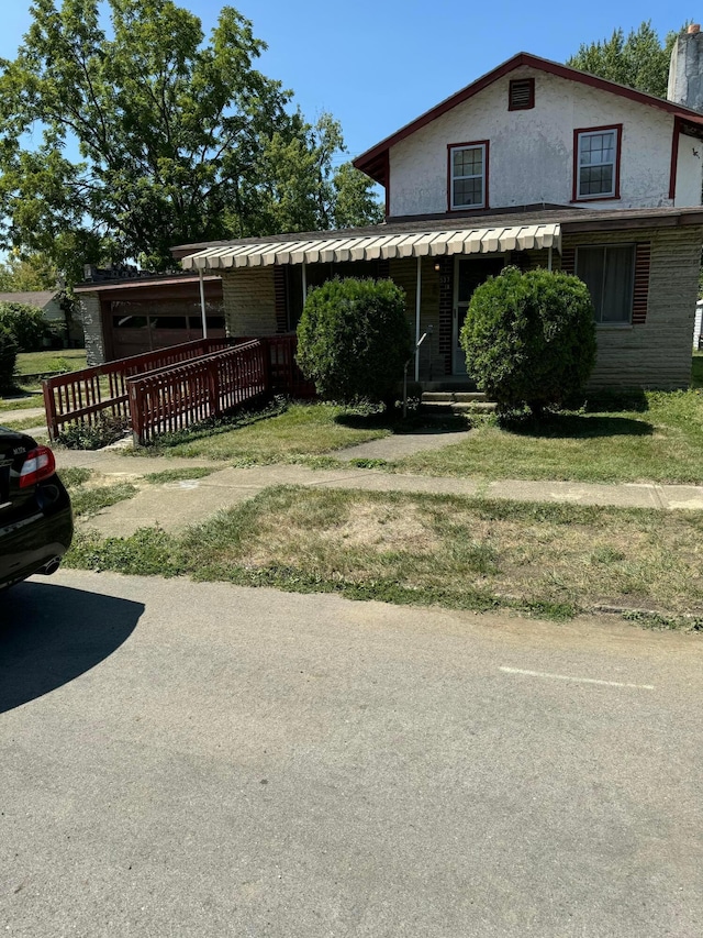 view of front of home featuring covered porch and a front yard