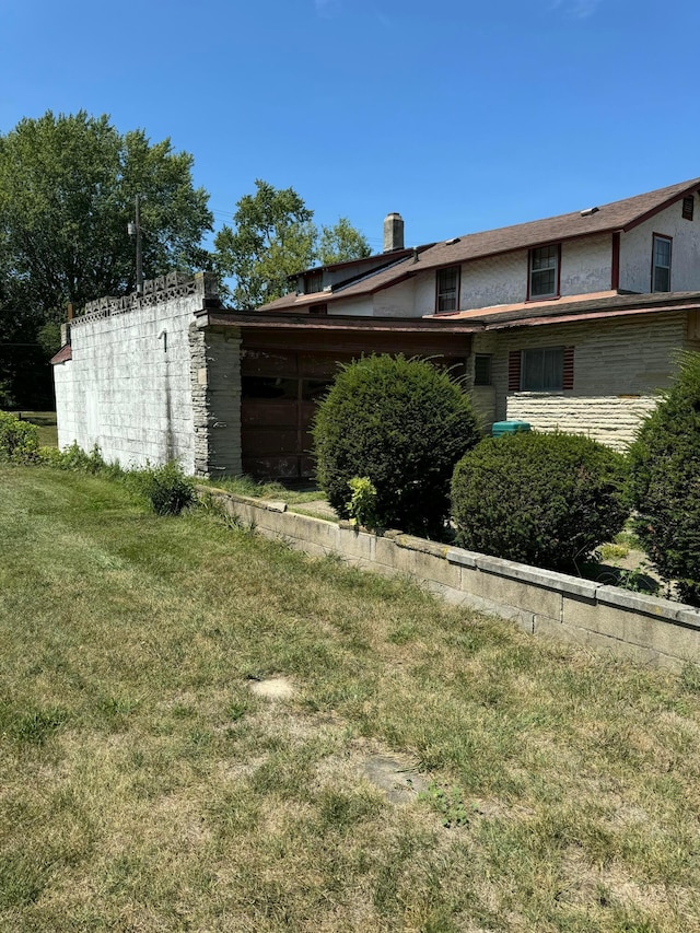 view of side of home featuring a yard