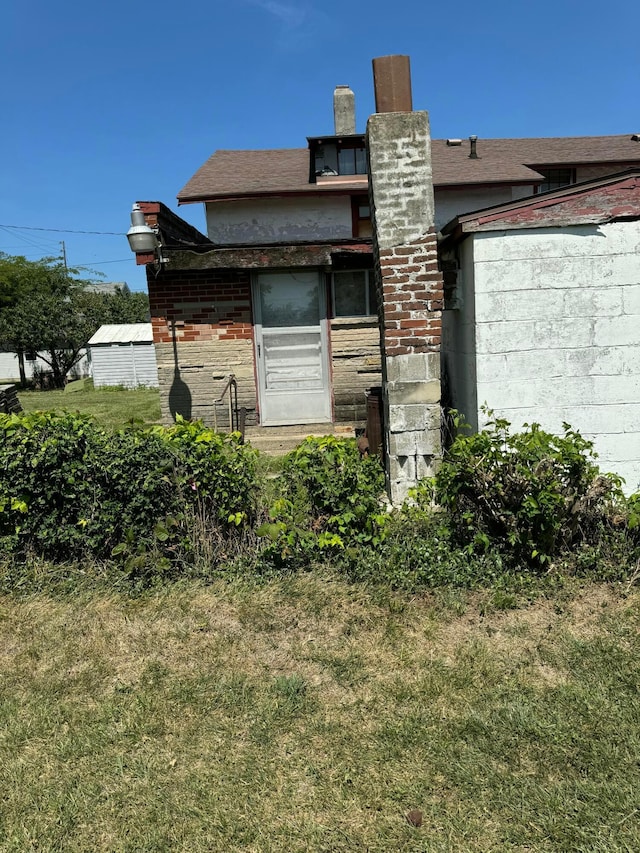 view of side of property with a lawn