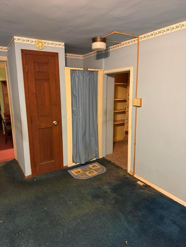 unfurnished bedroom featuring dark colored carpet