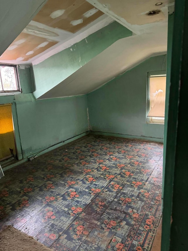 bonus room with carpet floors and lofted ceiling