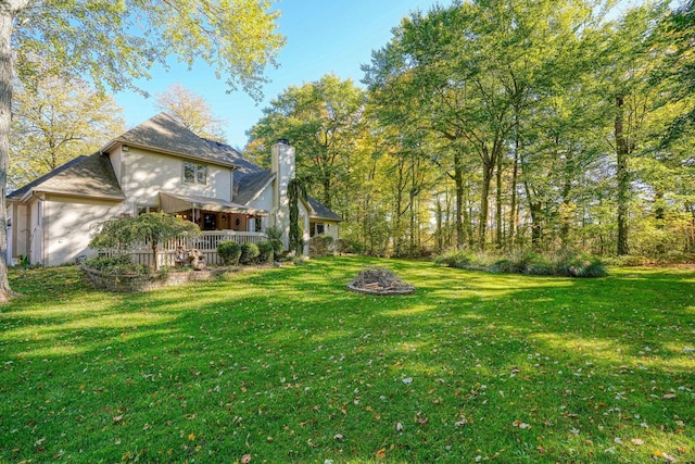 view of yard featuring a porch and a garage