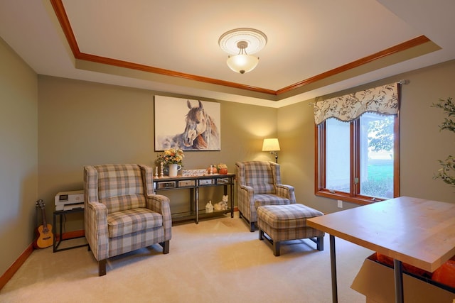 living area with a tray ceiling, light carpet, and ornamental molding