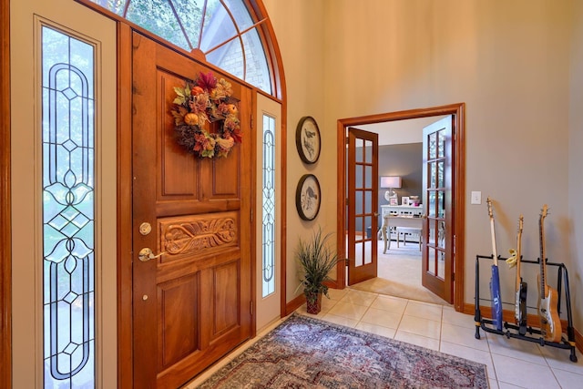 tiled foyer entrance featuring french doors