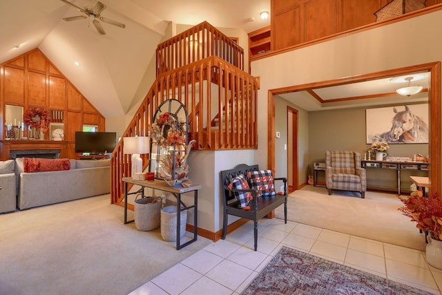 living room with ceiling fan, light tile patterned floors, and high vaulted ceiling