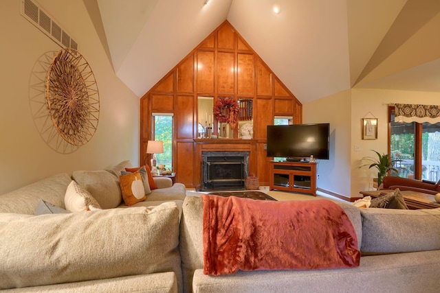 living room featuring high vaulted ceiling and a wealth of natural light