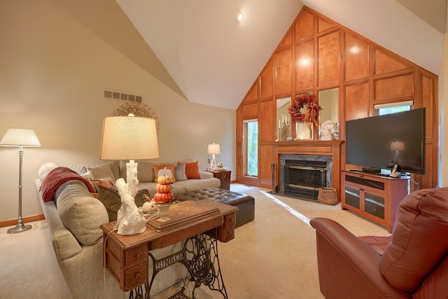 living room featuring high vaulted ceiling, a fireplace, and light carpet