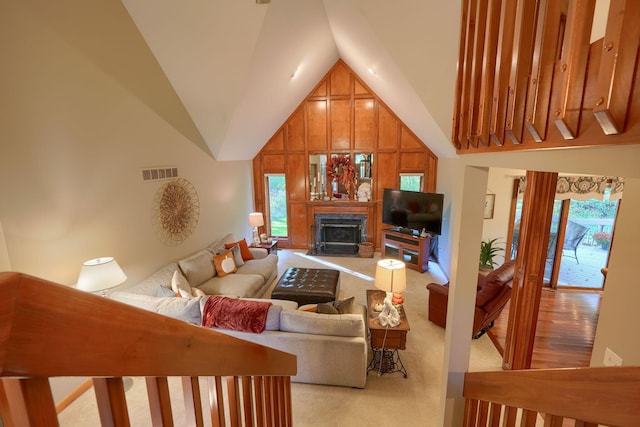 living room with light carpet and high vaulted ceiling