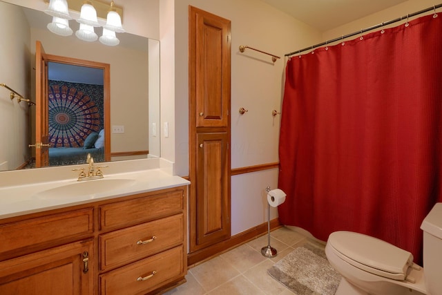 bathroom featuring tile patterned flooring, vanity, and toilet