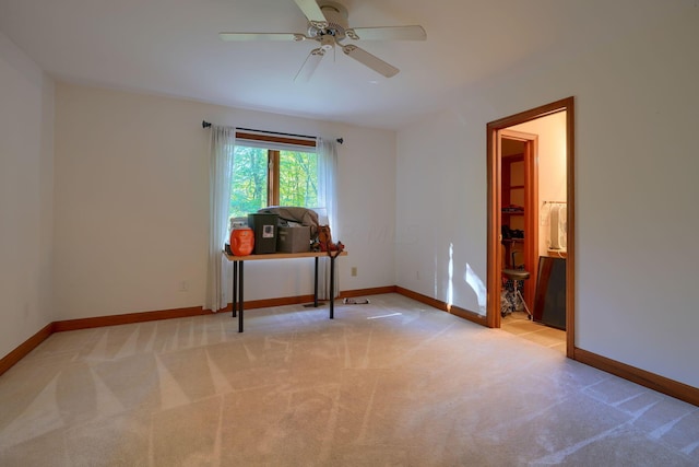 carpeted empty room featuring ceiling fan