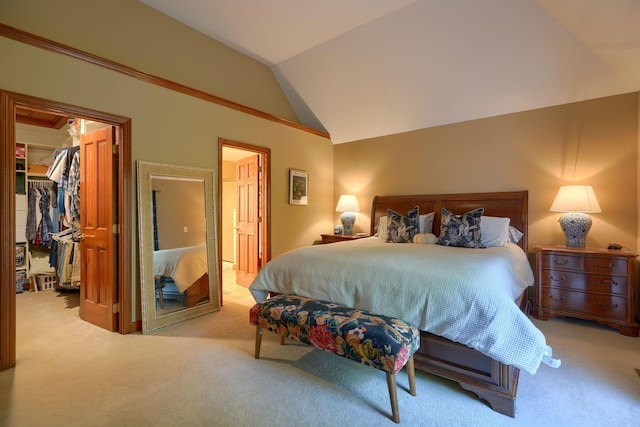 bedroom featuring a walk in closet, a closet, light colored carpet, and lofted ceiling