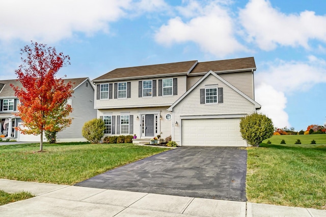 view of front of house with a garage and a front yard