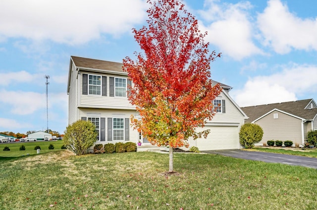 view of front of home featuring a front yard and a garage