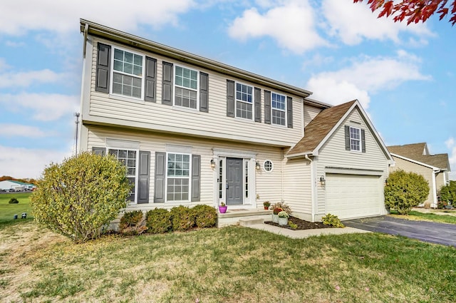 view of front of house with a front lawn and a garage