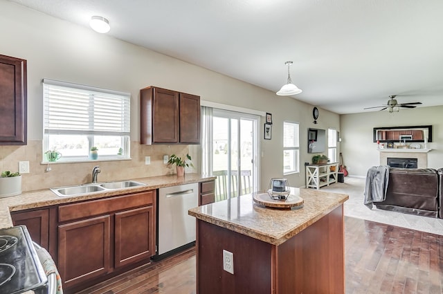 kitchen with sink, decorative light fixtures, a kitchen island, dark hardwood / wood-style flooring, and stainless steel appliances