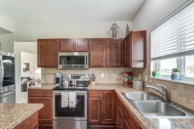 kitchen with backsplash, sink, and stainless steel appliances