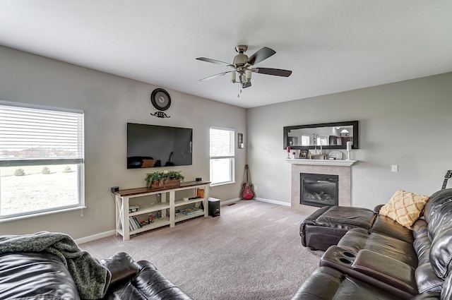 carpeted living room with ceiling fan and a fireplace