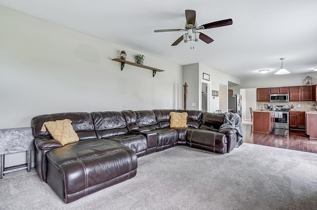 living room featuring ceiling fan and dark wood-type flooring