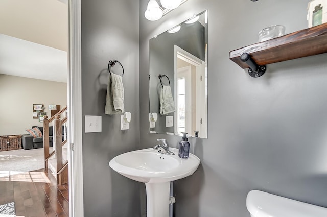 bathroom featuring hardwood / wood-style floors and toilet