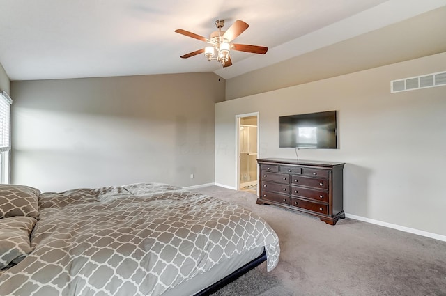 carpeted bedroom with ensuite bathroom, ceiling fan, and lofted ceiling